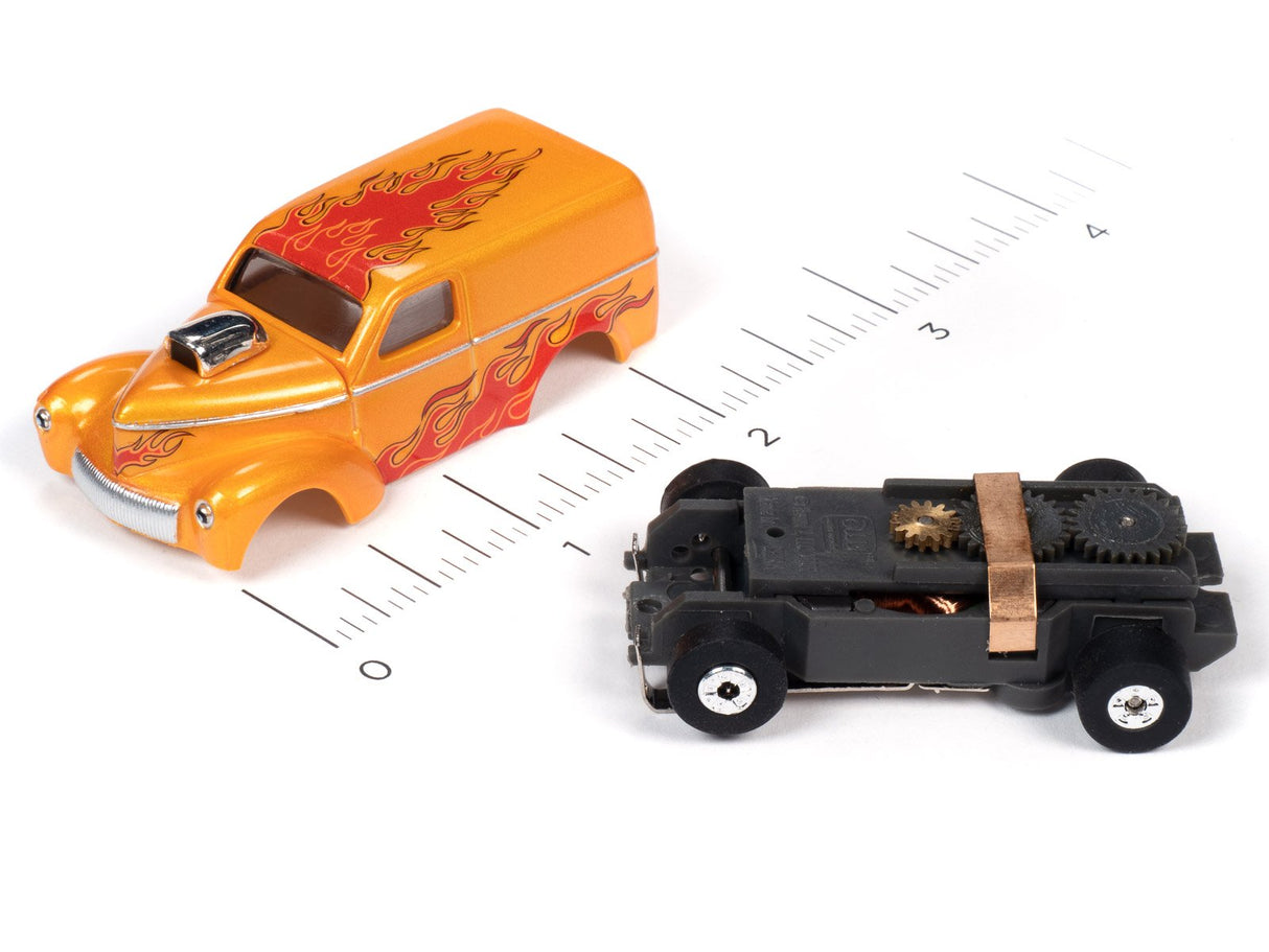 Orange toy car and black toy car on a ruler for scale for Auto World SC353