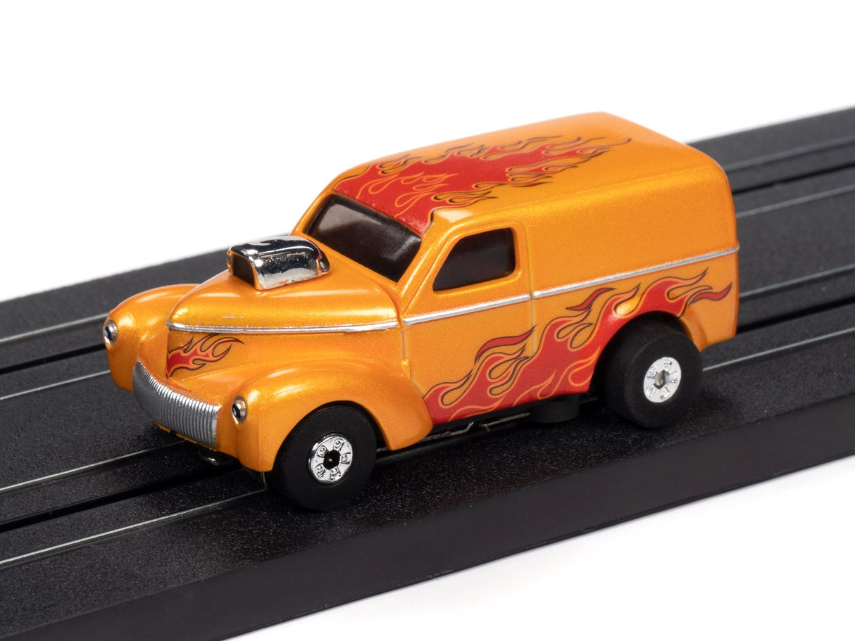 Orange vintage van toy car with red flame graphics on a black track for Auto World SC353
