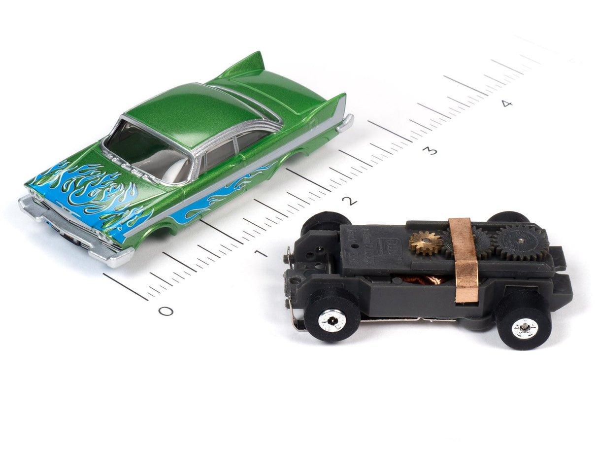 Green toy car with flames and a black toy car on a ruler for Auto World SC353