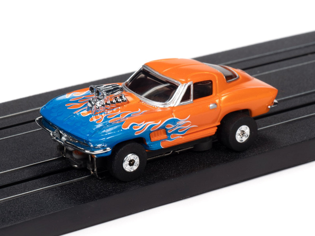 Orange and blue flame-detailed slot car on a black track for Auto World SC353
