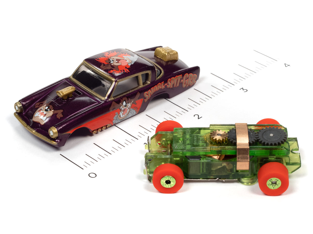 Two Looney Tunes Thunderjet toy cars on a ruler scale for Auto World SC363