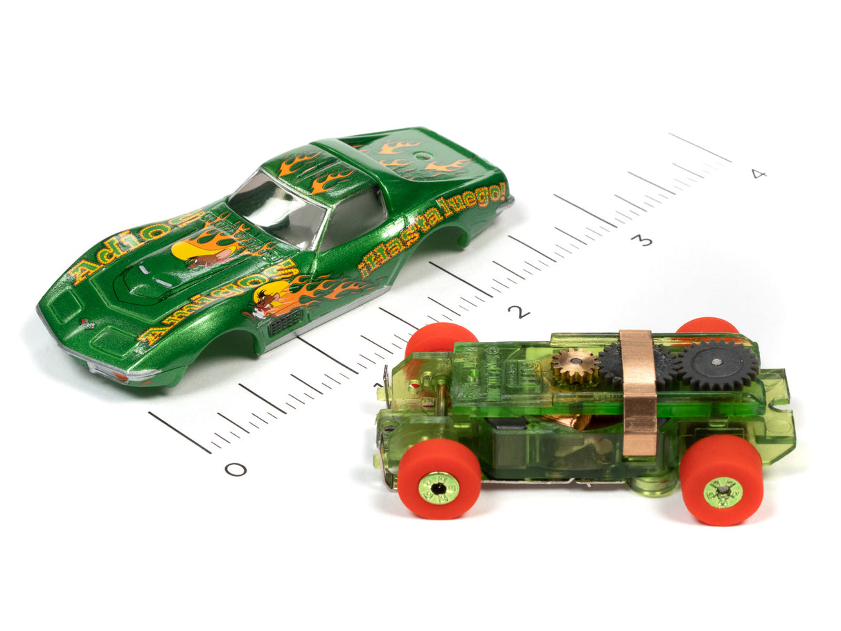 Green and clear toy cars on a ruler, representing Looney Tunes vehicles for Auto World SC363