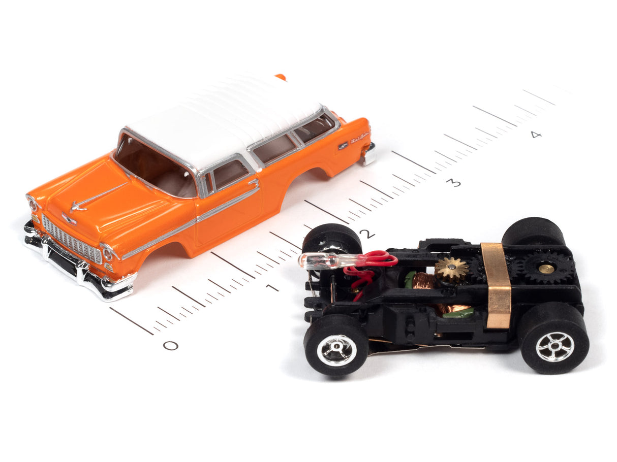Orange car and black flamethrower toy car on a ruler for Auto World SC366