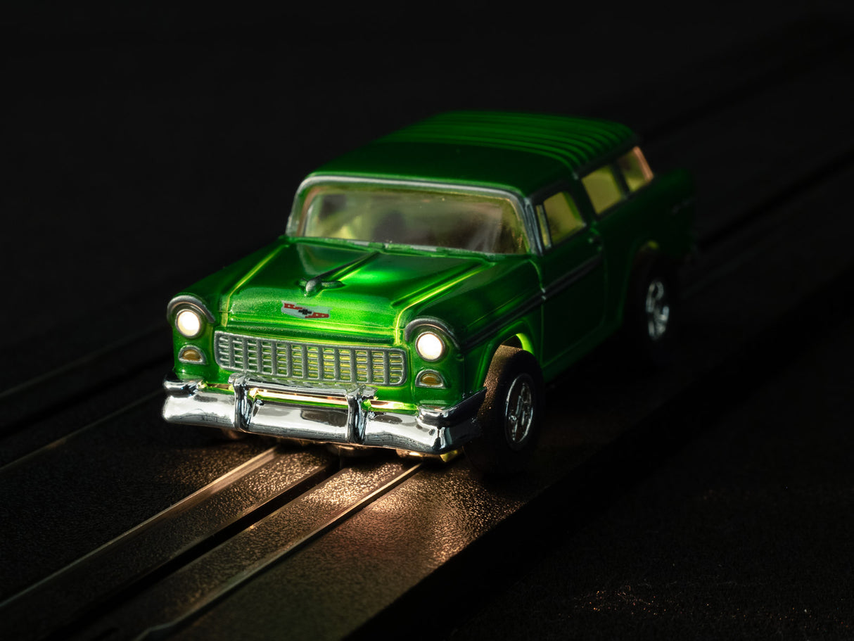 Green slot car on tracks with chrome bumper and headlights for Auto World SC366