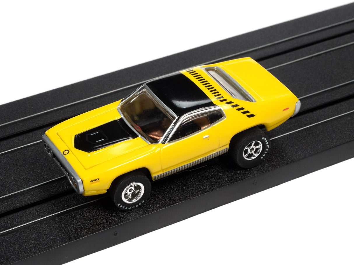 Yellow slot car toy on a black track for Auto World SC366