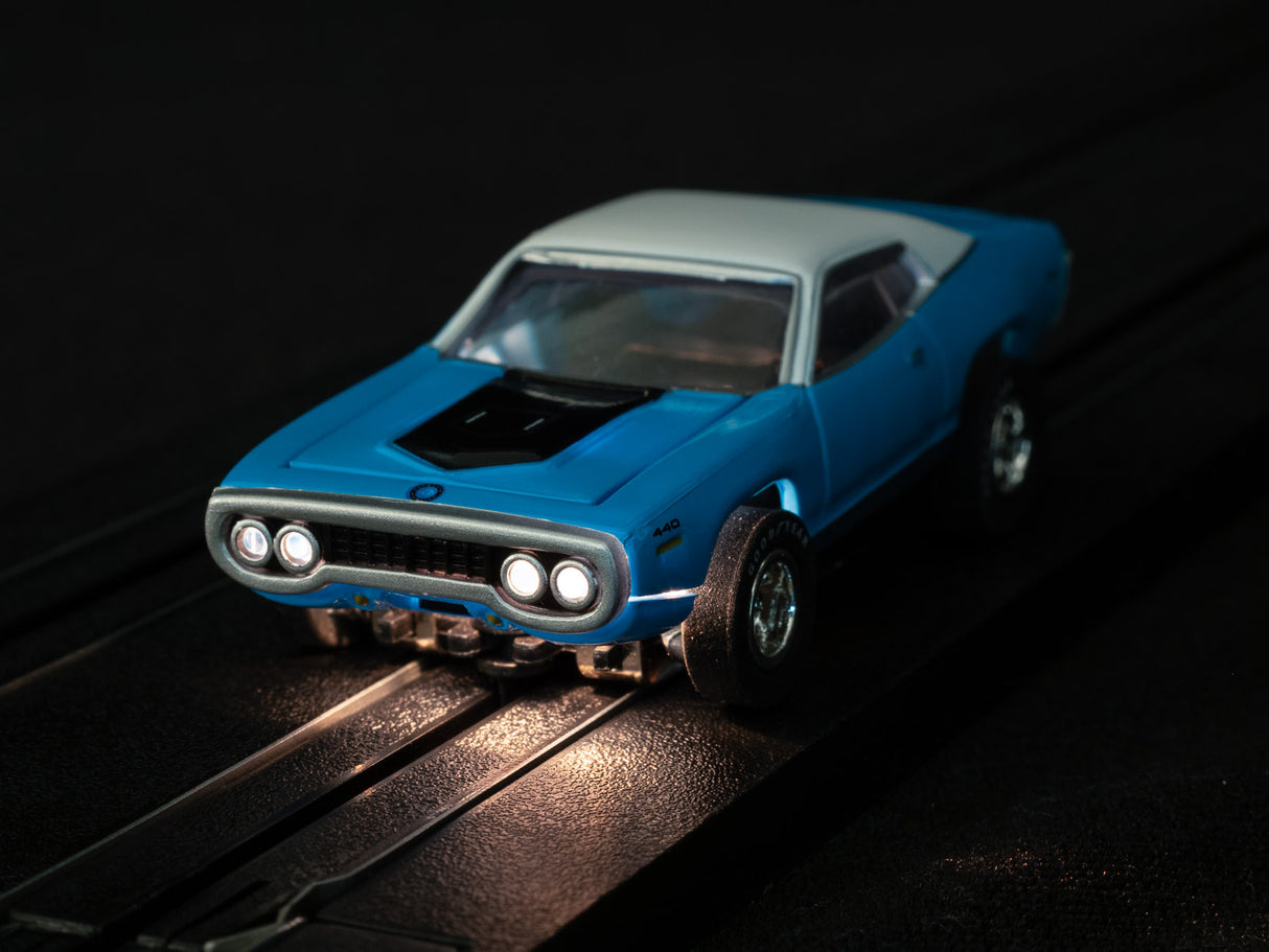 Blue and white slot car on black tracks for Auto World SC366