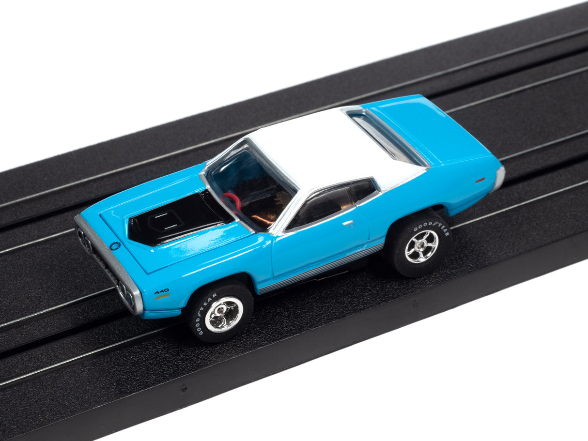 Blue and white slot car on a black track for Auto World SC366