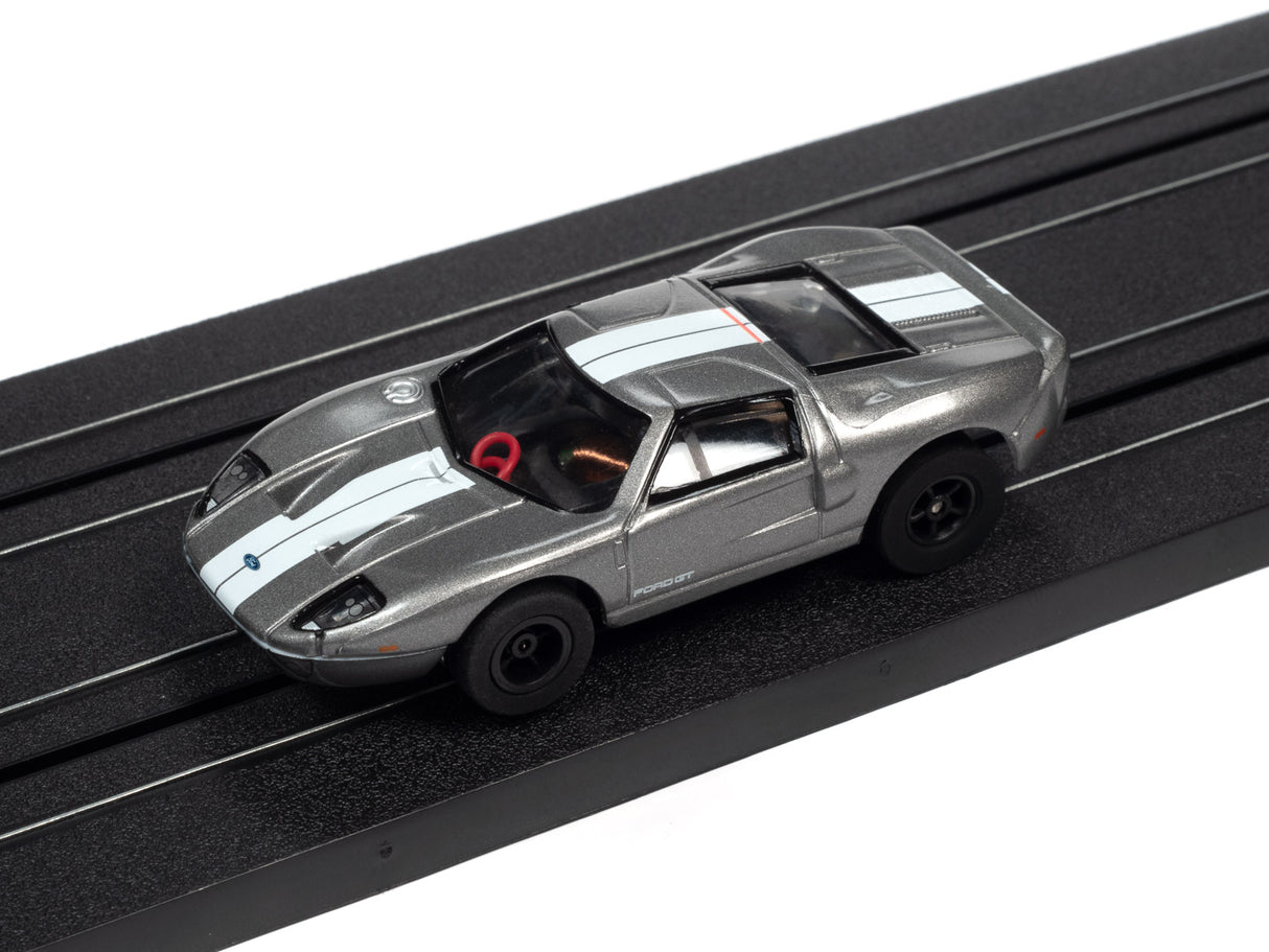 Silver Ford Mustang slot car on a black track for Auto World SC366