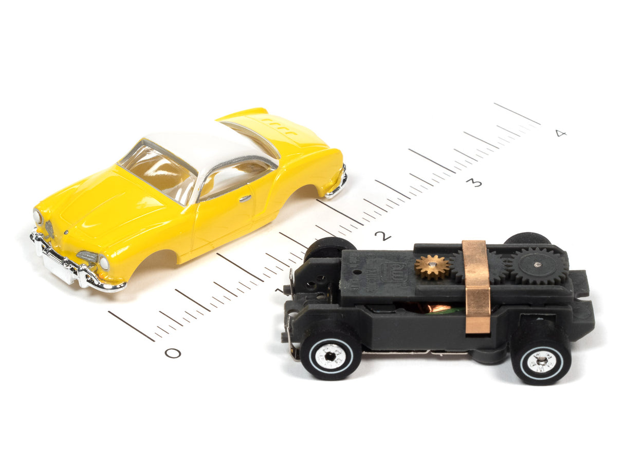 Yellow car and black toy vehicle on a ruler scale for Auto World SC367