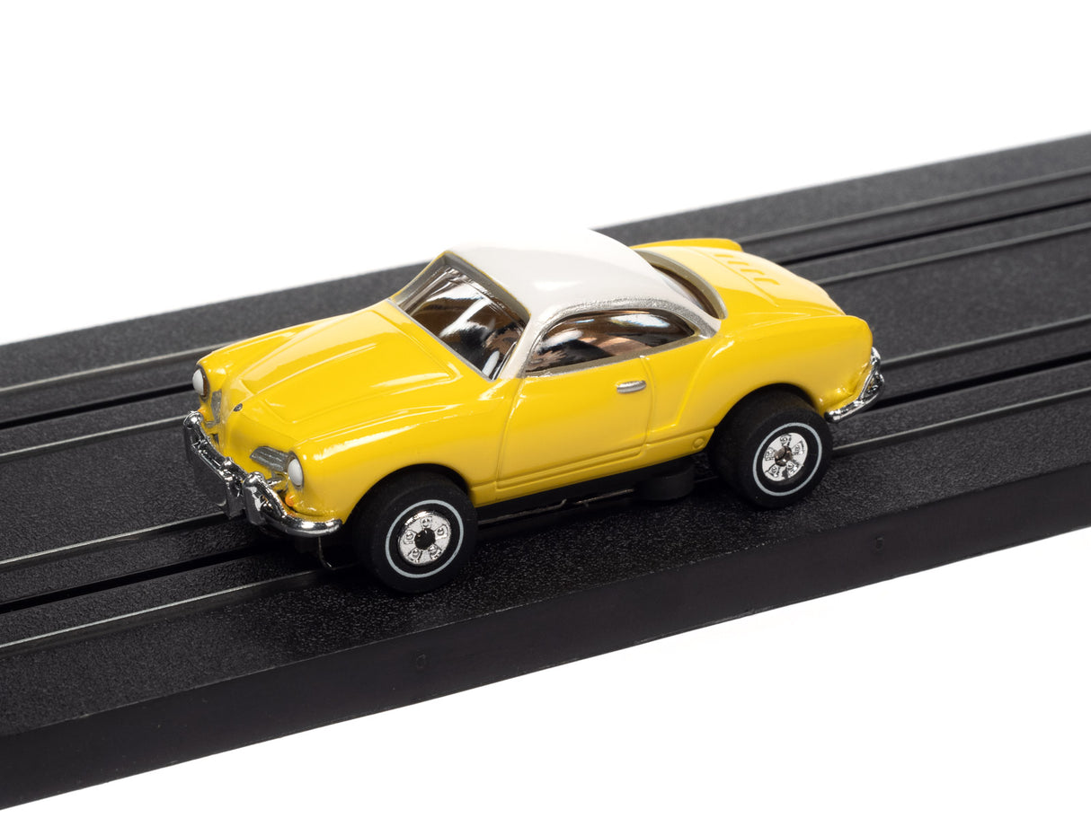 Yellow and white toy car on a black track for Auto World SC367