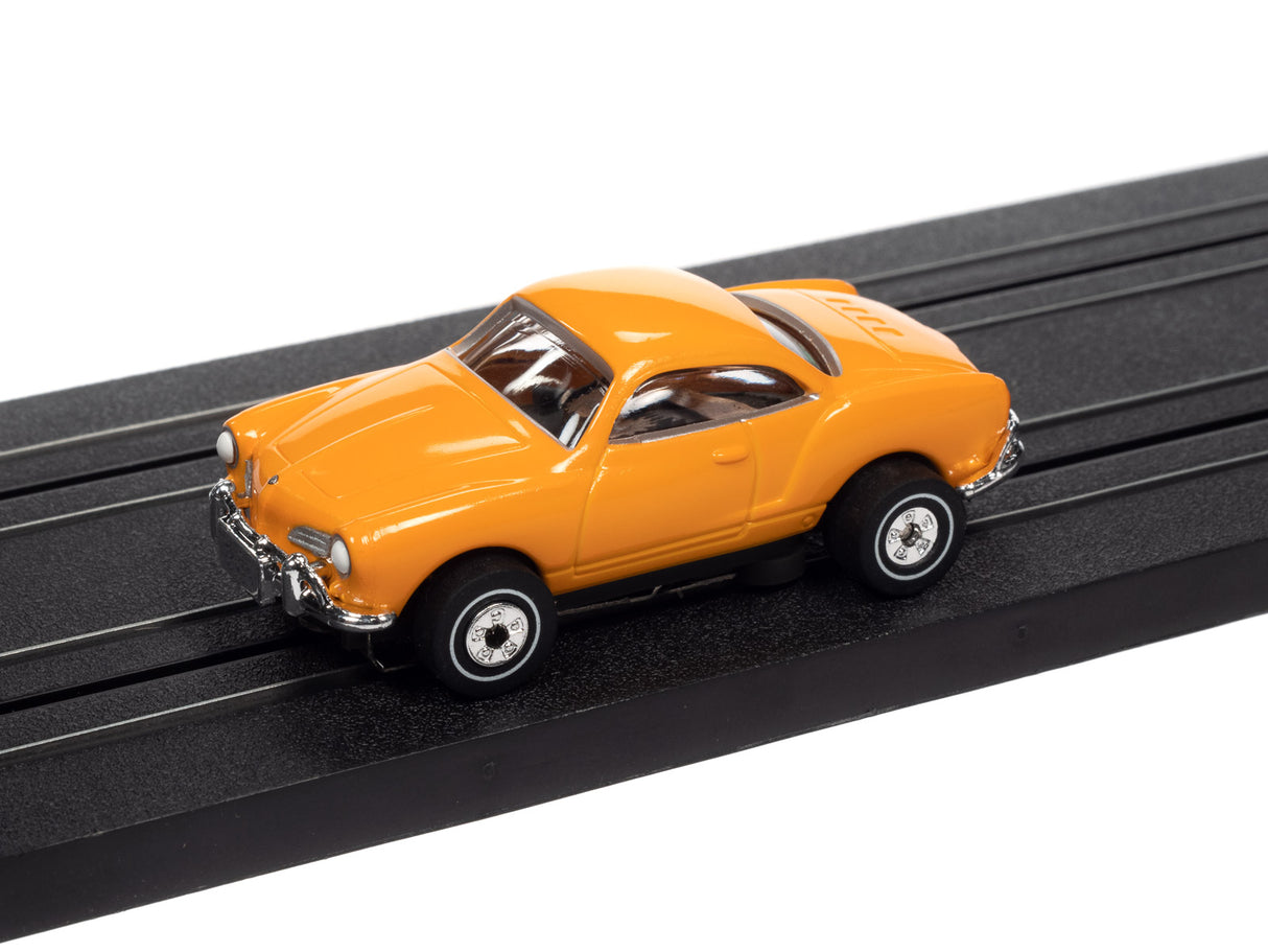 Yellow toy car on black track for Auto World SC367