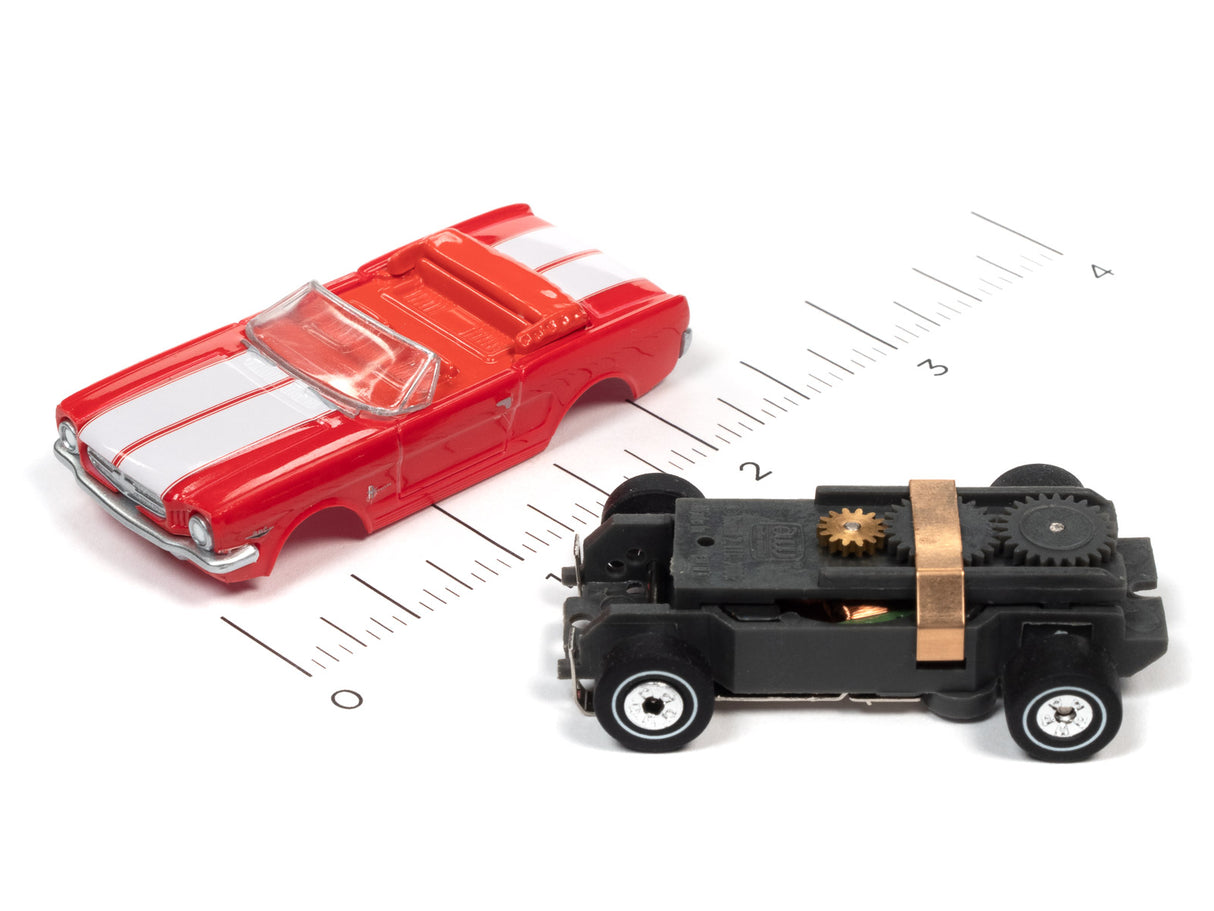 Red car and black vehicle toy toys on a ruler for Auto World SC367
