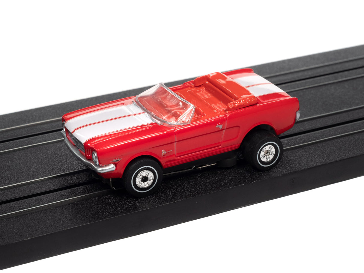 Red and white toy car on black track for Auto World SC367