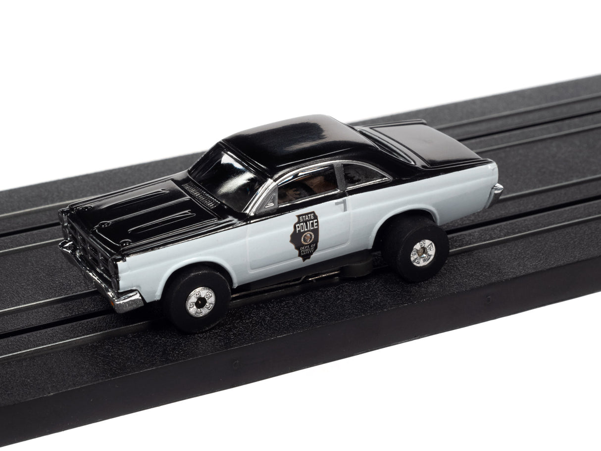 Black and white police car toy on a black track for Auto World SC367