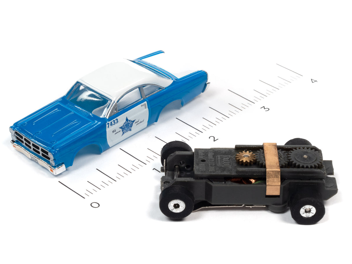 Blue car and black toy vehicle on a ruler scale for Auto World SC367