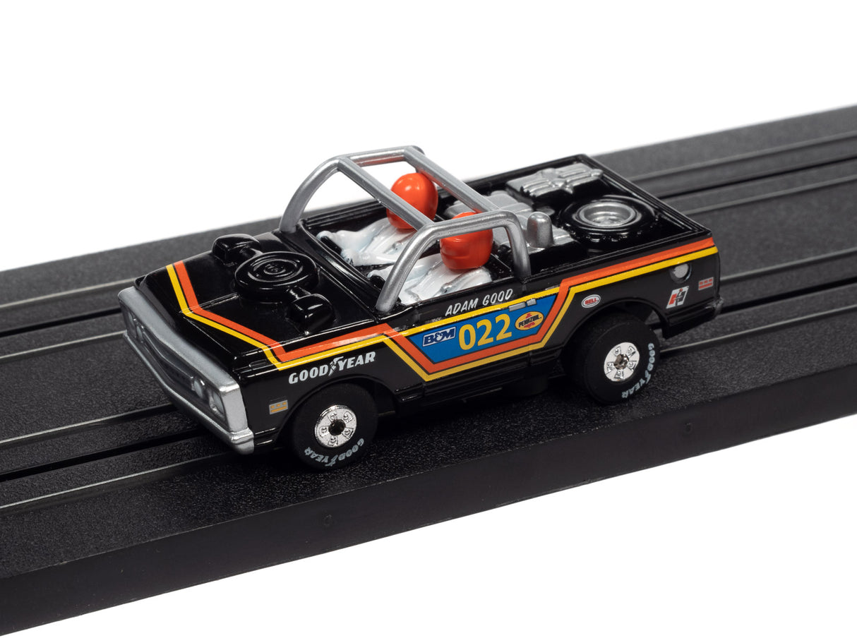 Slot car toy race car on a black track for Auto World SC367
