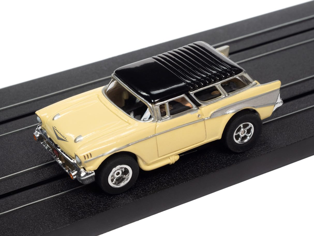 Yellow and black classic car toy on a black track for Auto World SC368