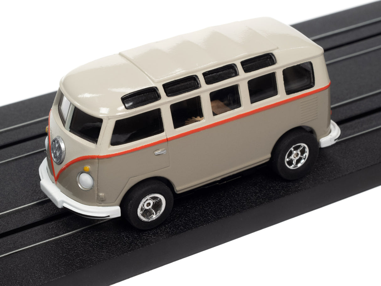 Scale model of a vintage, light-colored bus on black tracks for Auto World SC368