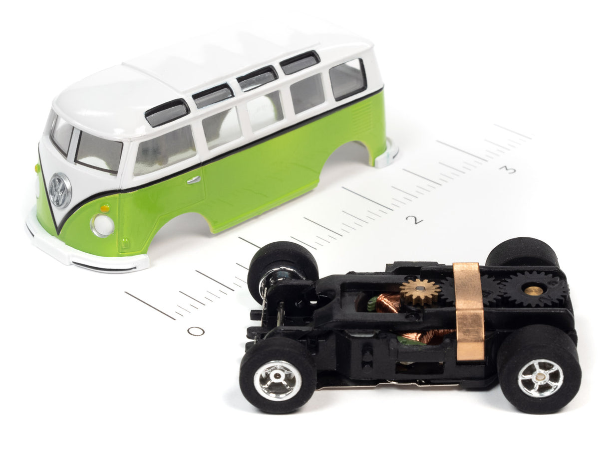 Green and white school bus toy next to a black toy car for Auto World SC368