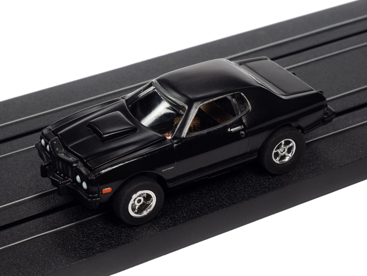 Black slot car on a black track section for Auto World SC368