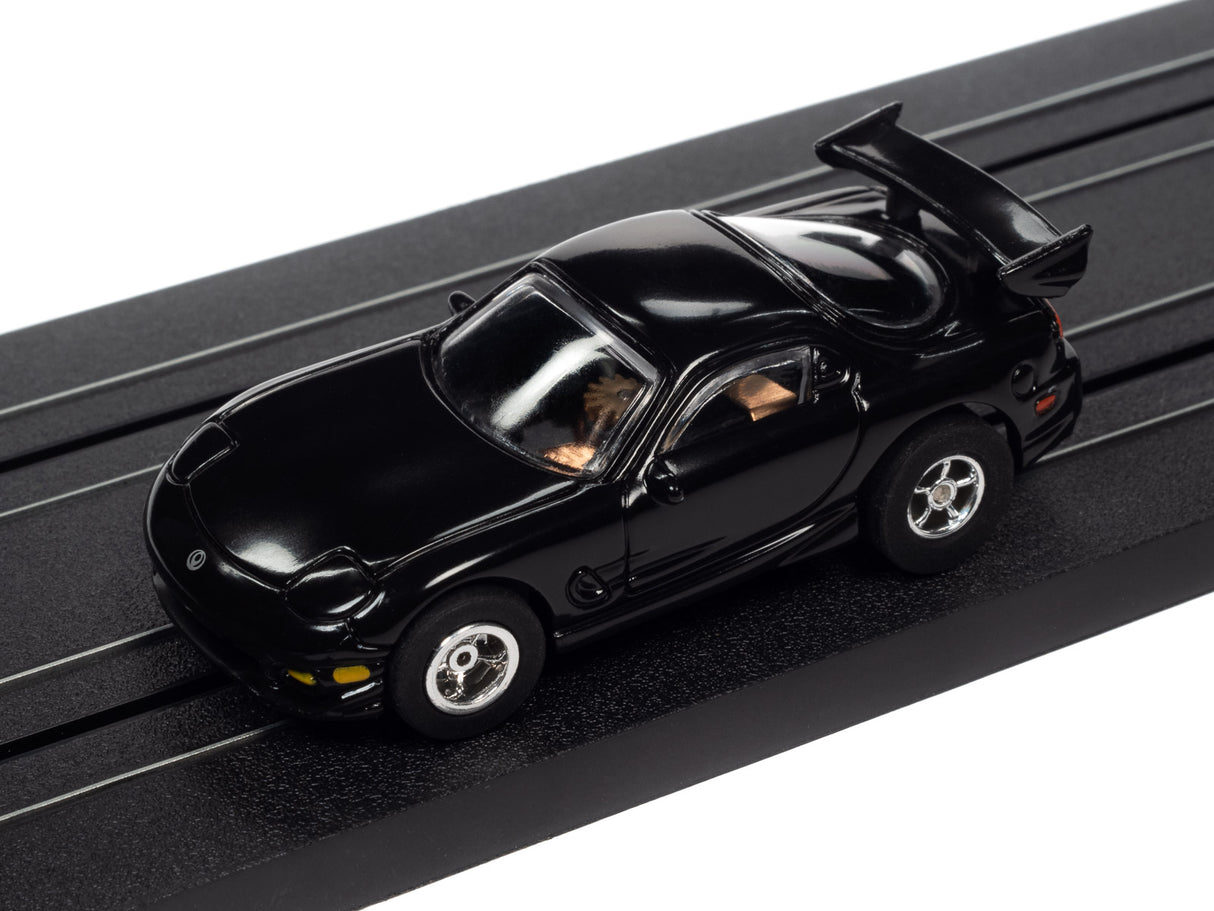 Black slot car with open hood, displayed on a track for Auto World SC368