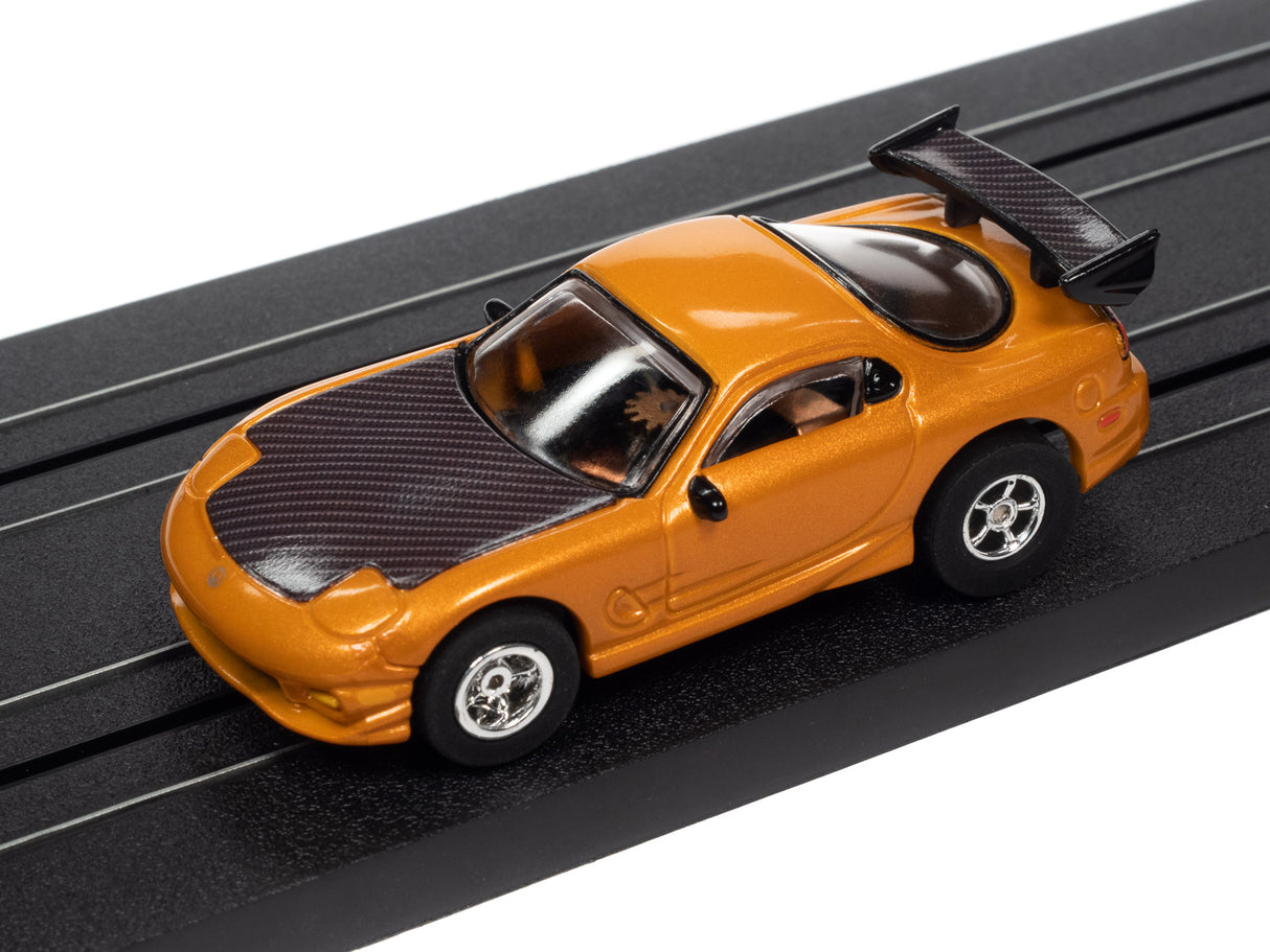 Orange race car toy on a black track for Auto World SC368