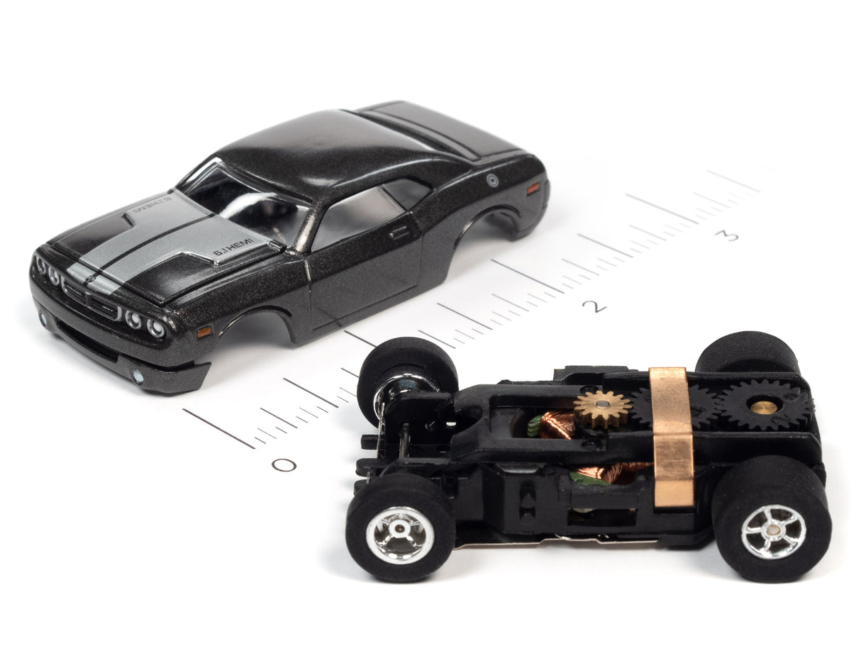 Black slot car model with visible undercarriage showing gears for Auto World SC368