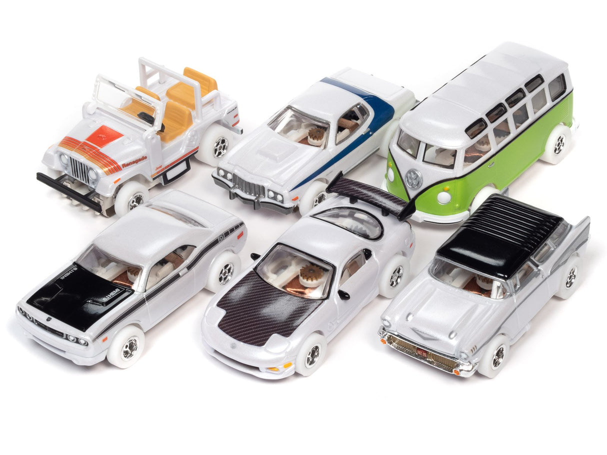 Assortment of slot car toy vehicles on white background for Auto World SC368