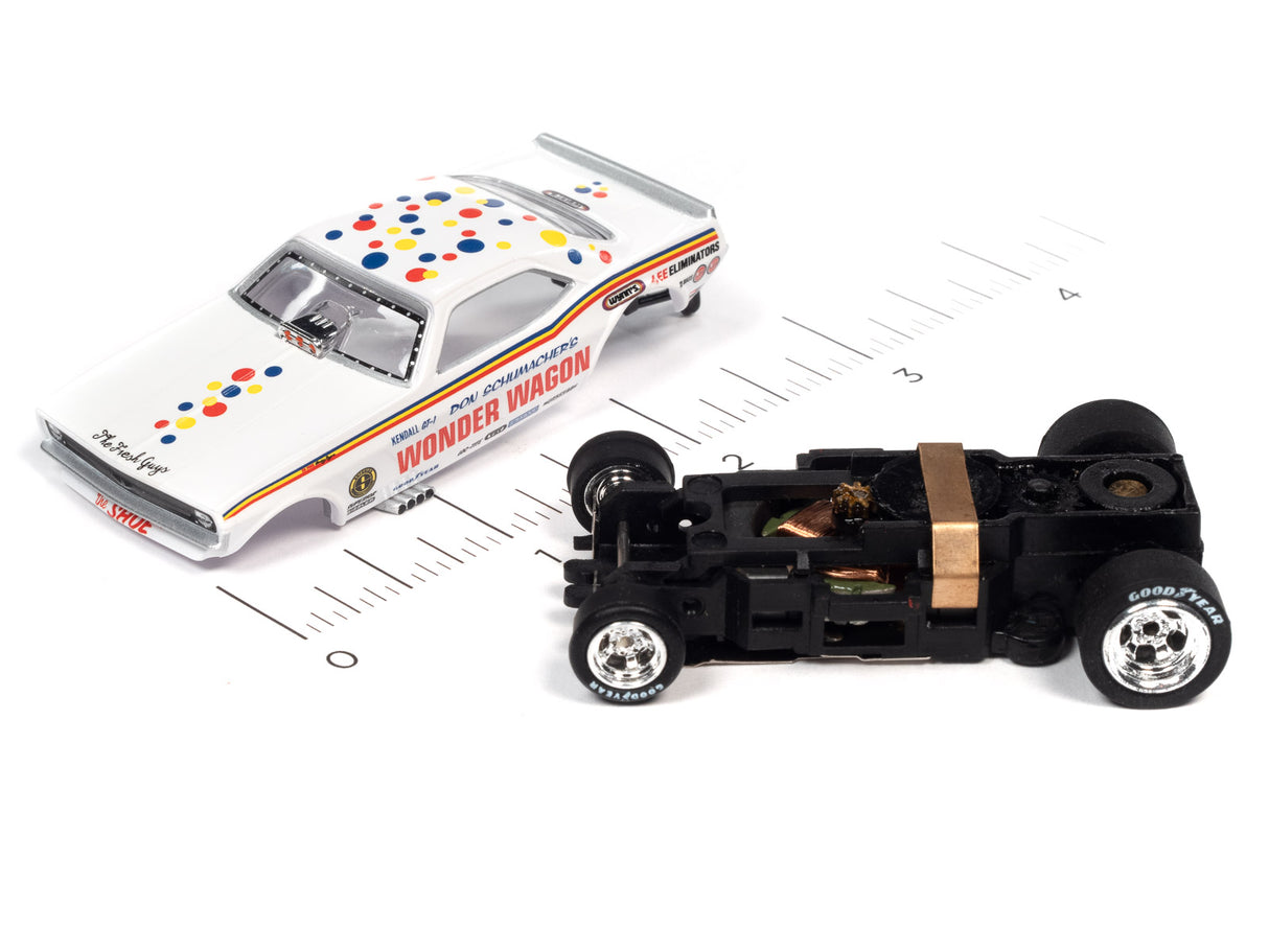 White and red toy car with colorful dots, next to a black slot car for Auto World SC369