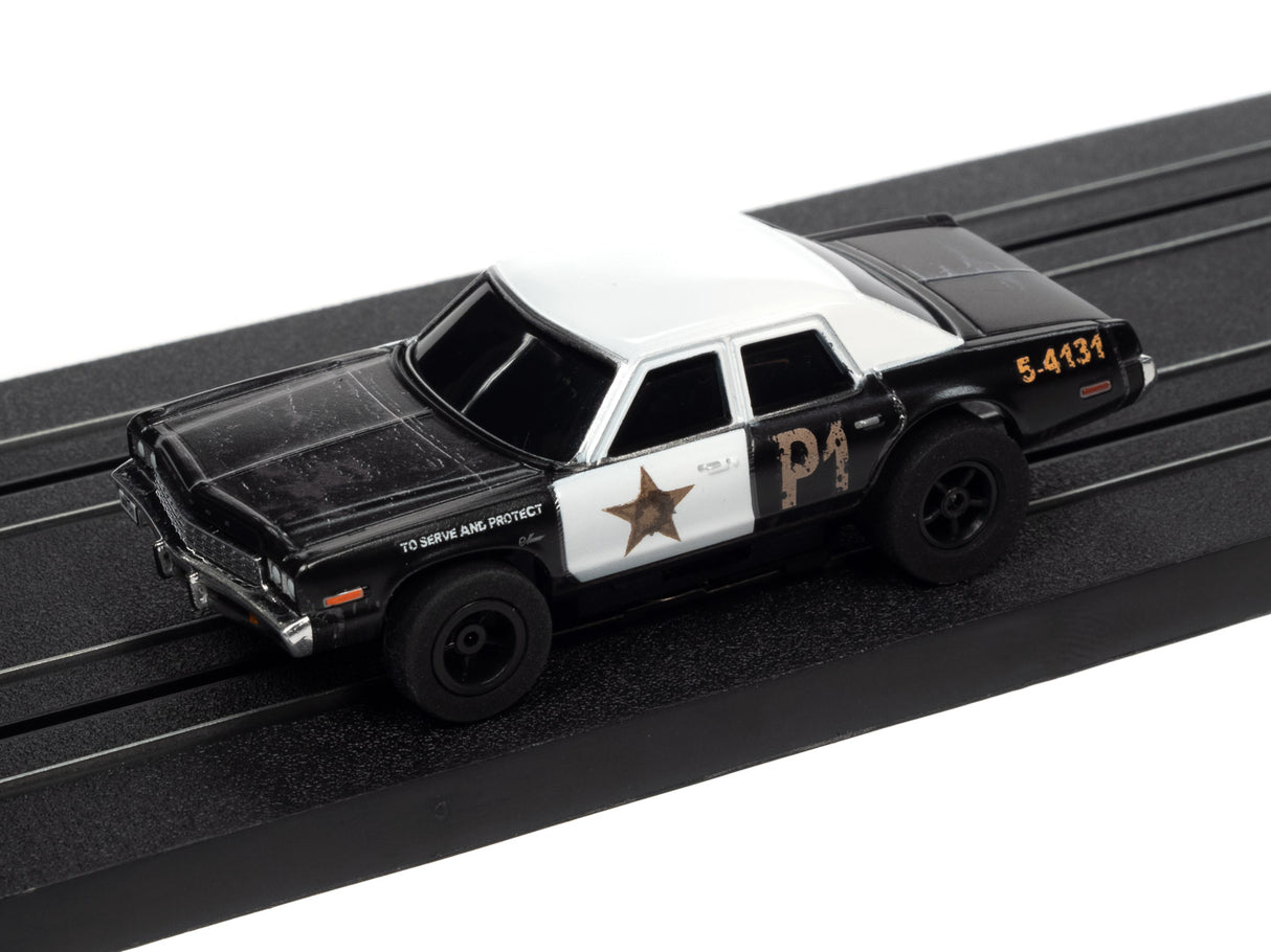 Black and white slot car toy on a black track for Auto World SC372