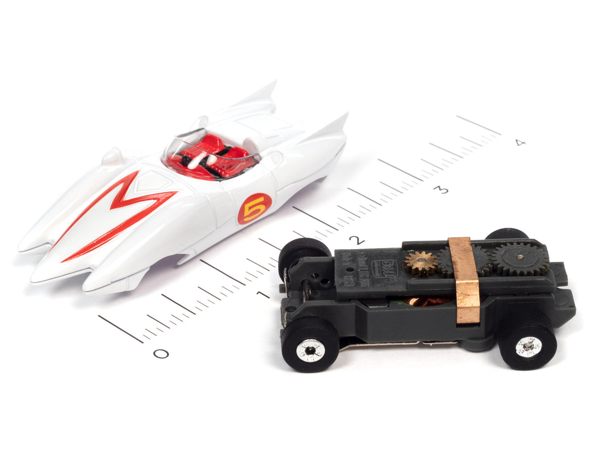 White and black toy cars on a ruler scale for Auto World SC372
