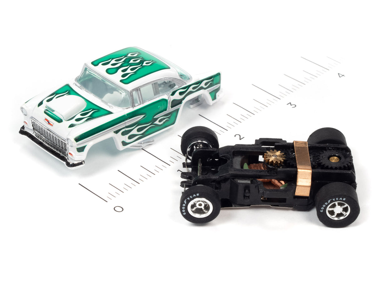Green and white race car and black car on a ruler scale for Auto World SC373