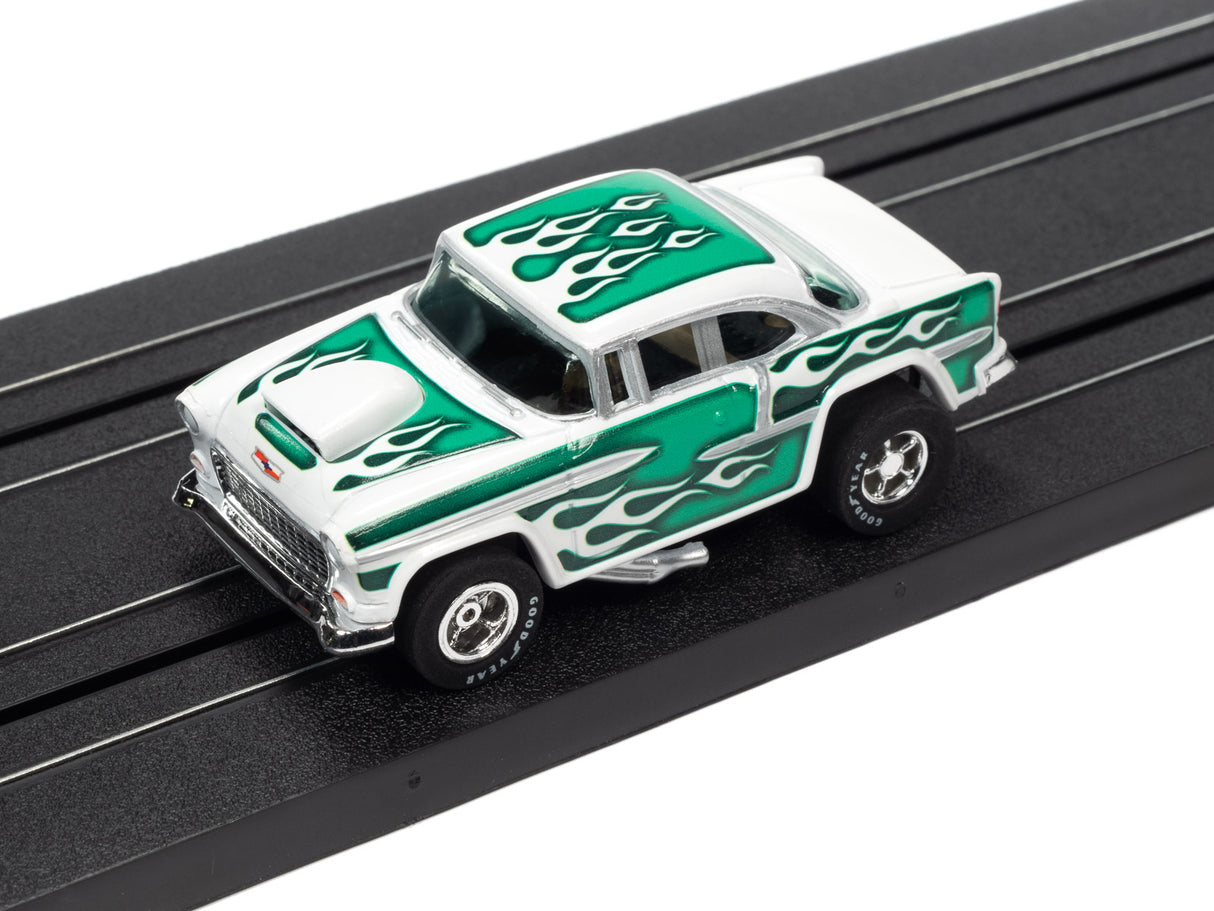 White and green slot car toy on a black track for Auto World SC373