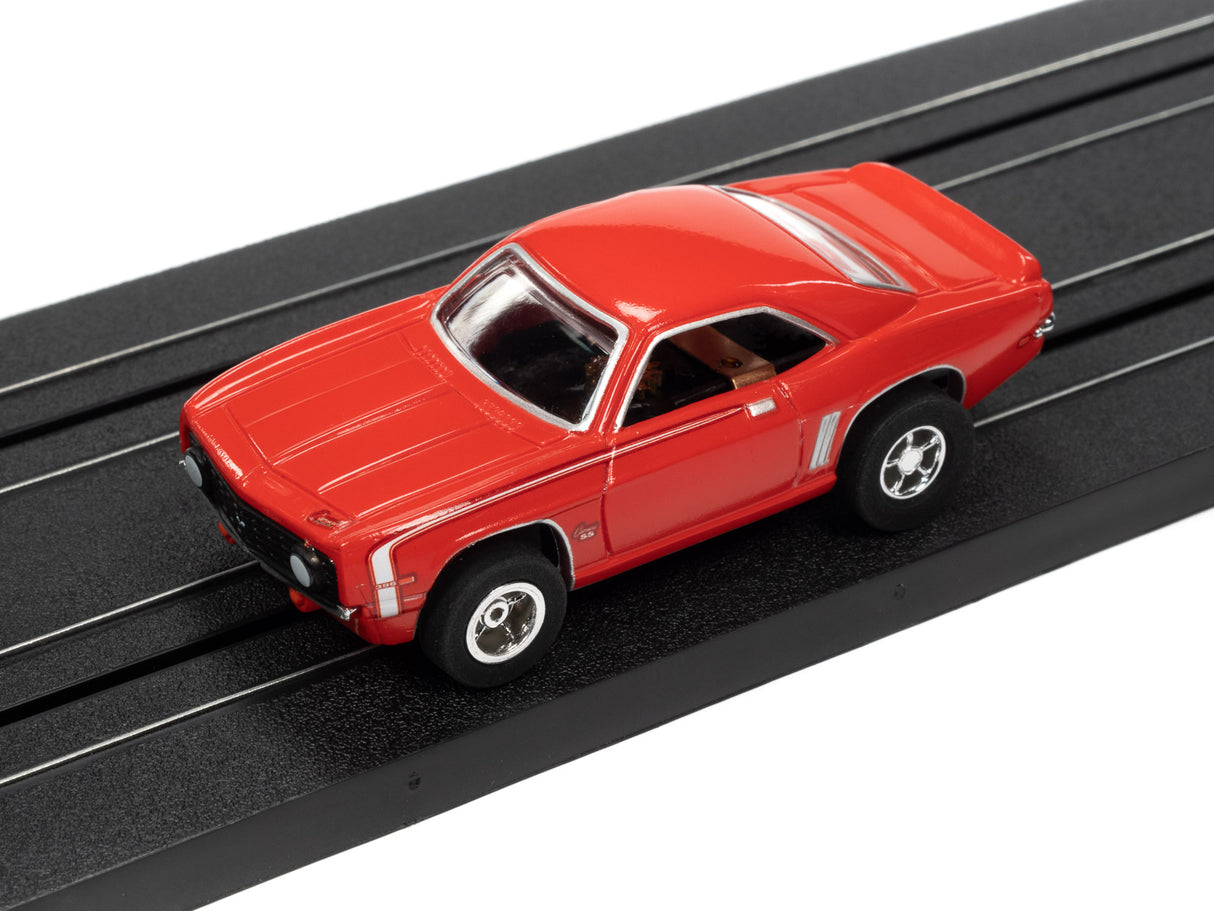 Red slot car toy on a black train track for Auto World SC373
