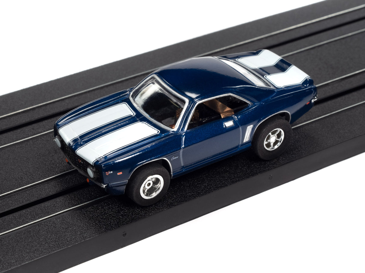 Blue and white striped slot car on a black track for Auto World SC373