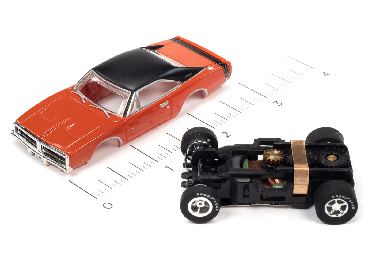 Red slot car and black motorized car on a ruler for Auto World SC373