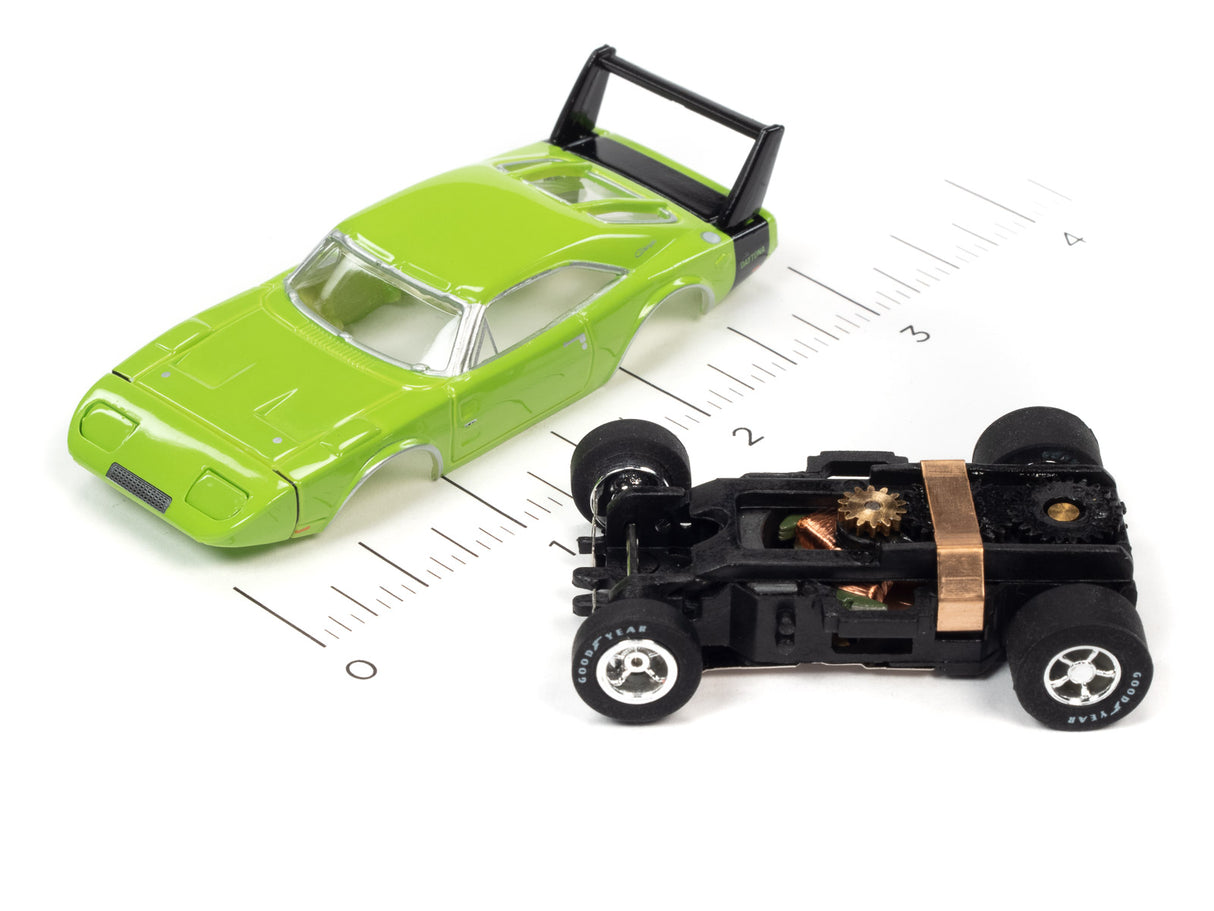 Green toy car and black race car on a ruler for scale for Auto World SC373
