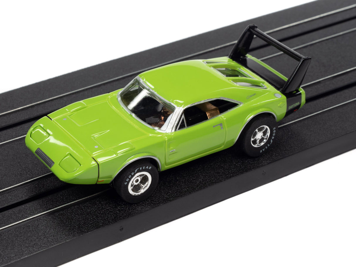 Bright green slot car race car on a black track for Auto World SC373