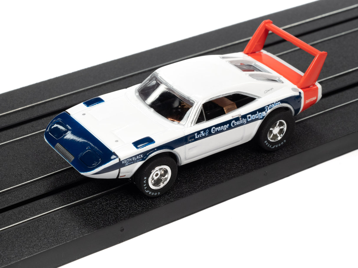 White and blue slot car with red tow hook on a black track for Auto World SC373