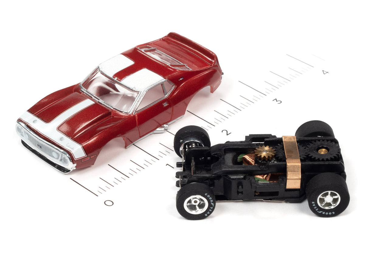 Red and white race car and black race car on a ruler for Auto World SC373