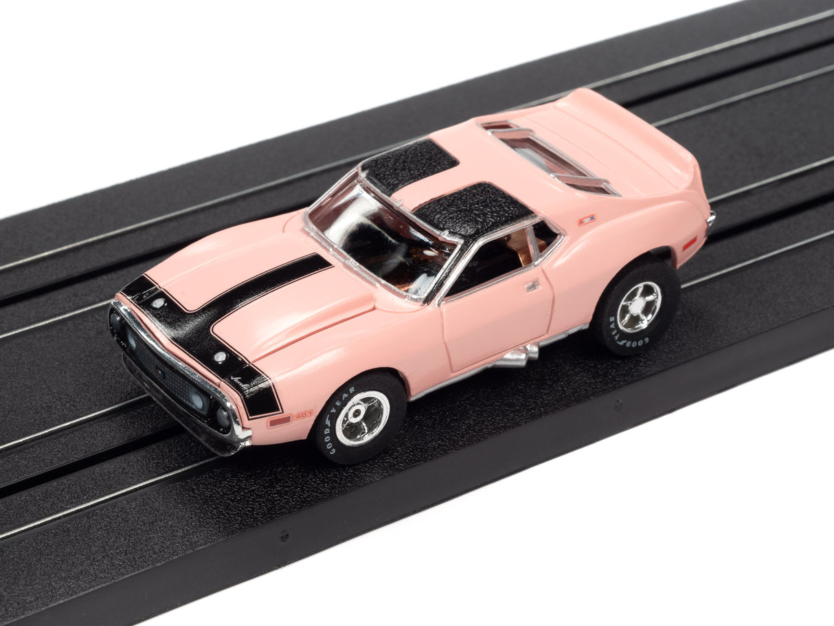 Pink and black striped slot car on a black track for Auto World SC373
