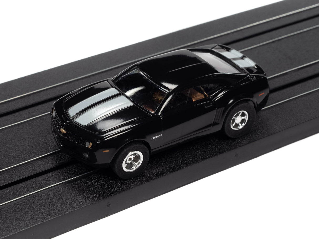 Black slot car on a black track section for Auto World SC373