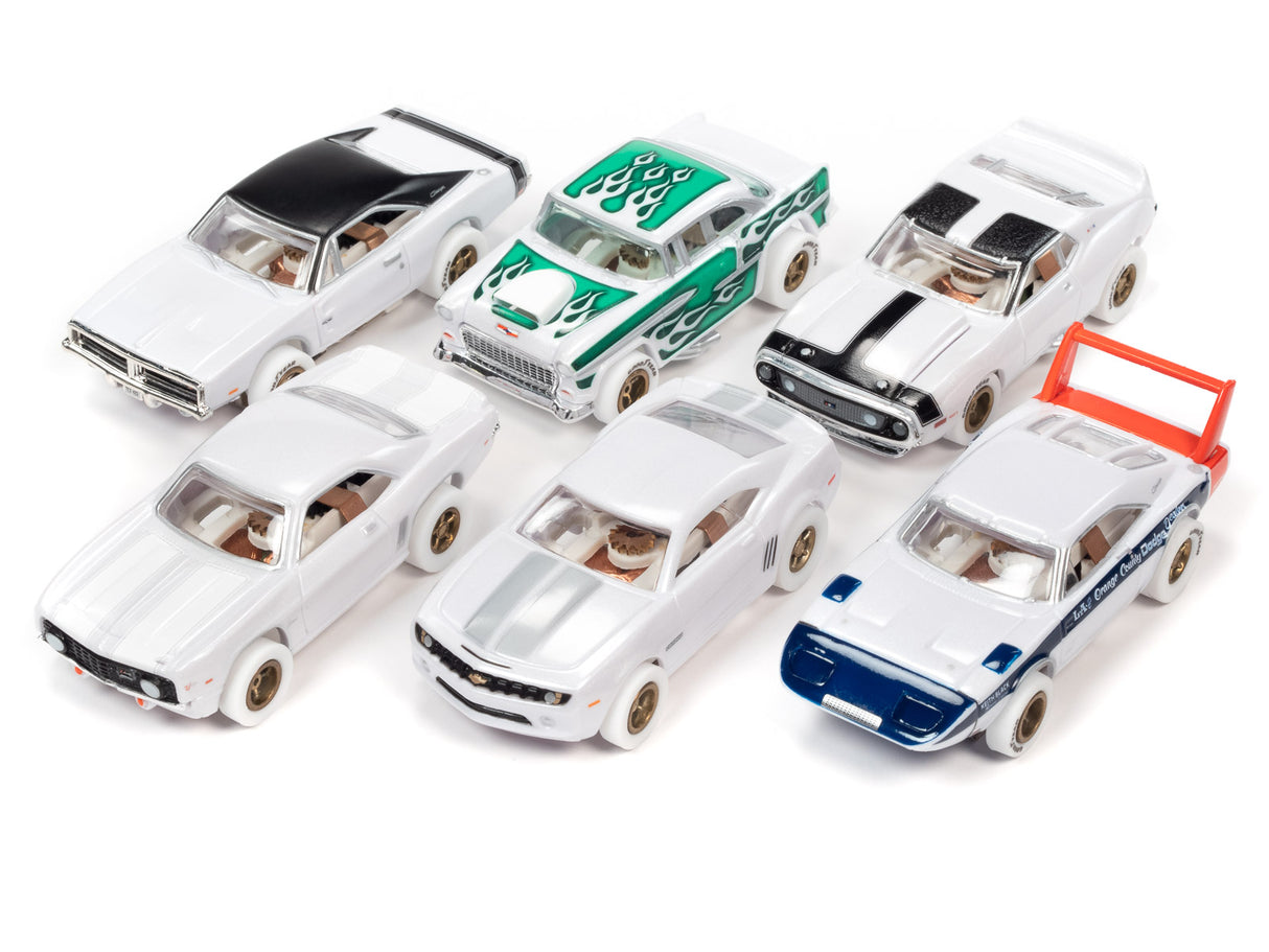 Assortment of slot car toy cars on white background for Auto World SC373