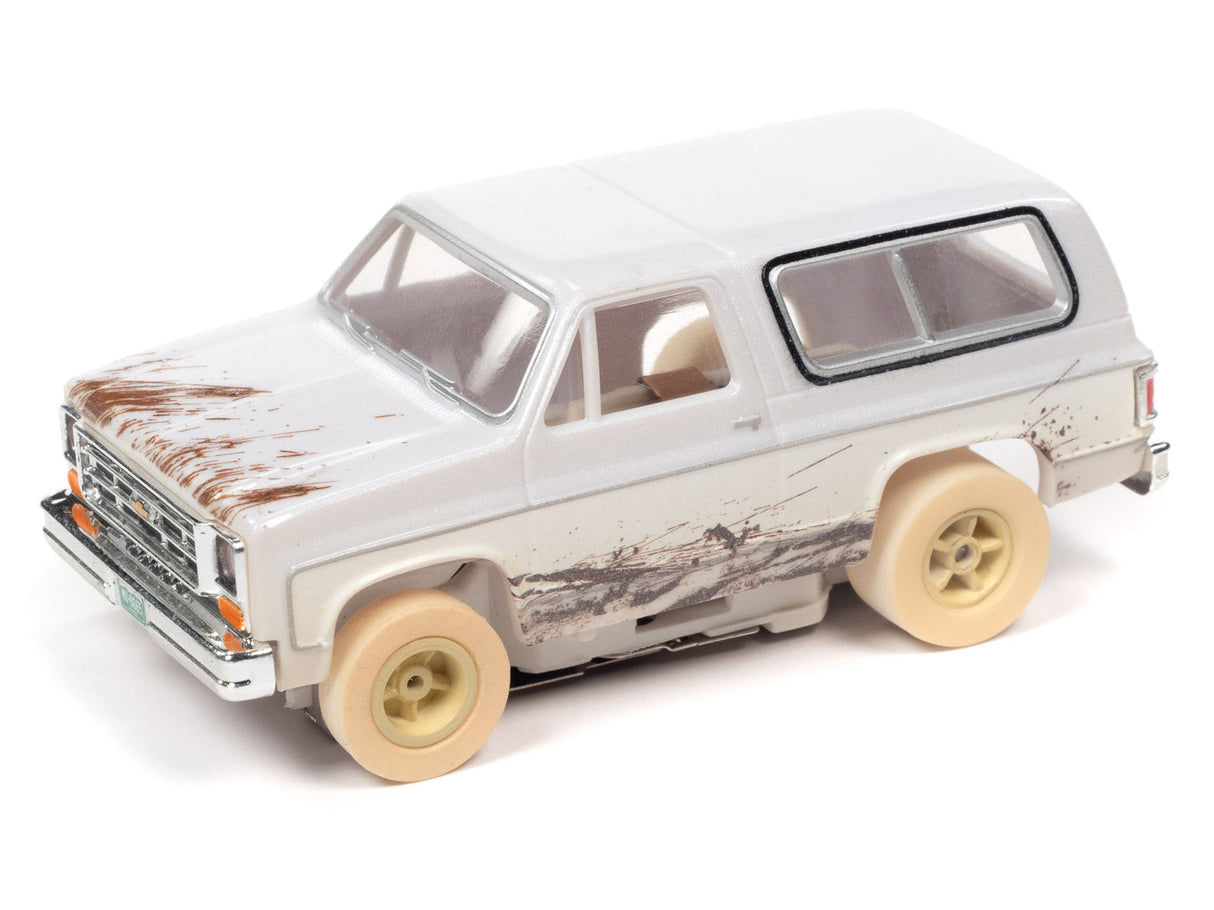 White off-road toy truck with dirty weathering and tan wheels for Auto World SC375