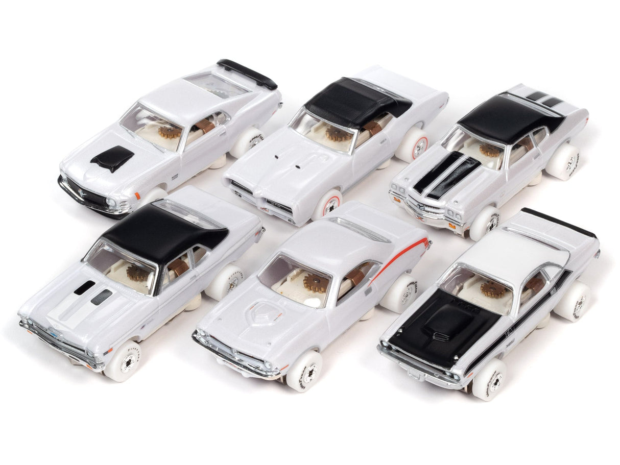 Collection of miniature white and black toy cars on a white background for Auto World SC377