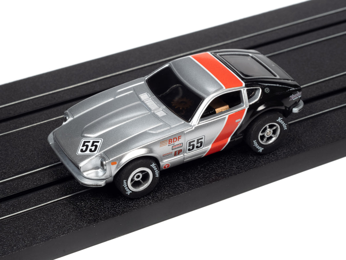 Silver and black race car toy on a black track for Auto World A SC378