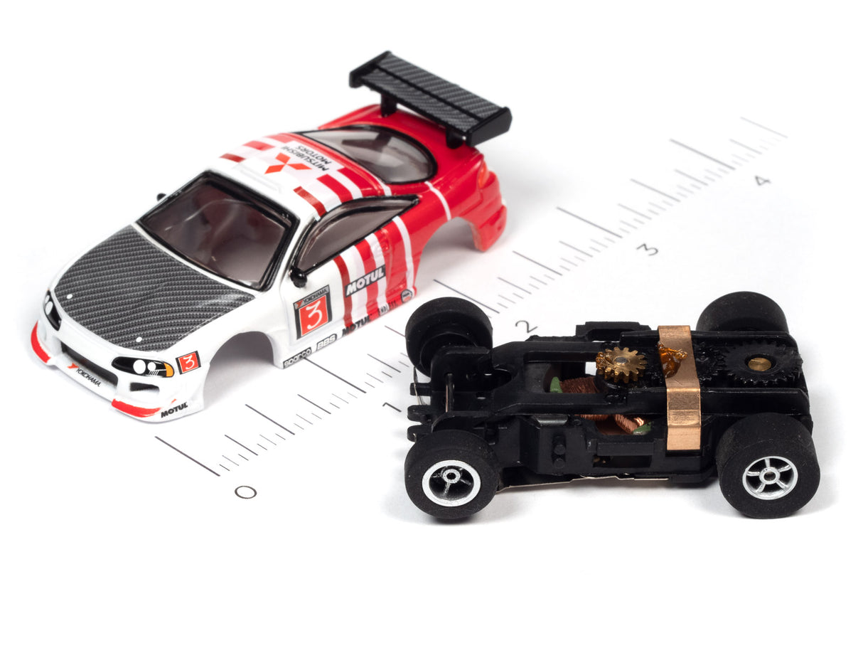 Red and white race car toy next to a black, open-wheel car toy for Auto World A SC378
