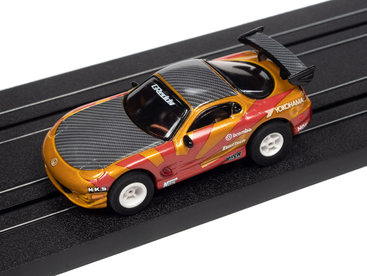 Yellow and black race car toy on a black track for Auto World A SC378