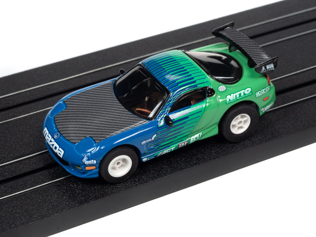 Blue and green race car toy on a black track for Auto World A SC378