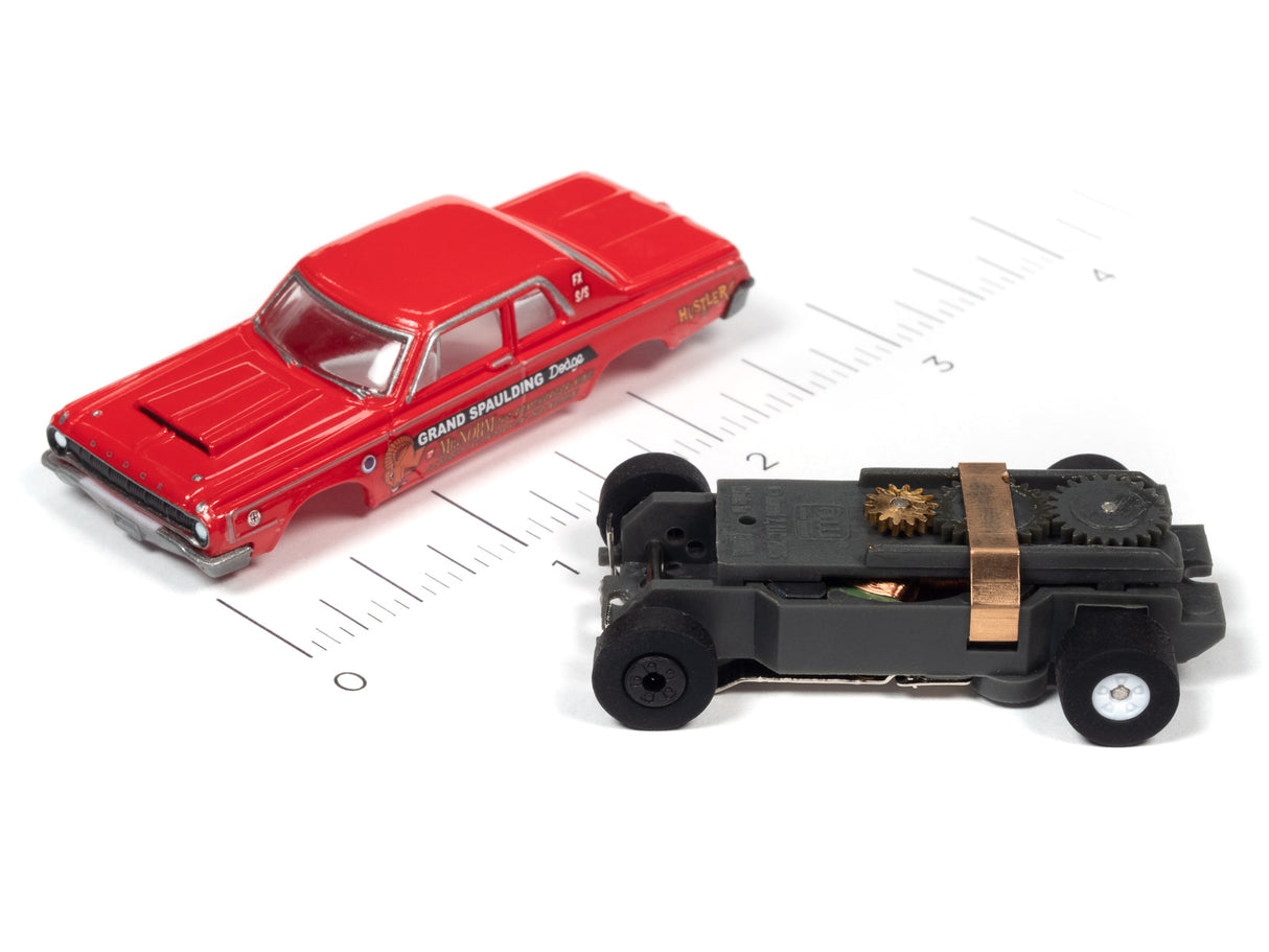 Red and black toy cars on a ruler scale for Auto World SC379